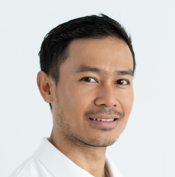Content confident handsome Asian businessman looking at camera